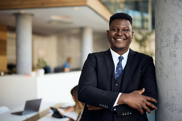 istock Confident Businessman Smiling in a Modern Office Setting with Natural Light 2204931428
