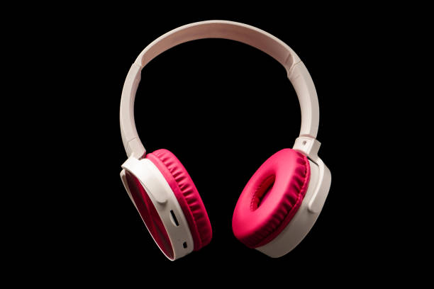 istock Pink and white headphones isolated on a black background. 2204931517