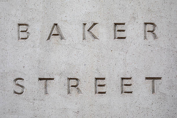 A Bank sign above a stone building entrance, strong signs of weathering and age.