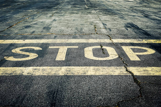 The inscription stop on an asphalt road.