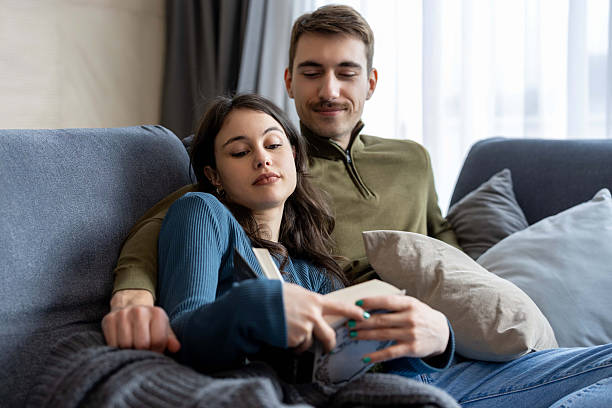 istock Couple Enjoying a Quiet Reading Moment on the Couch 2204936740