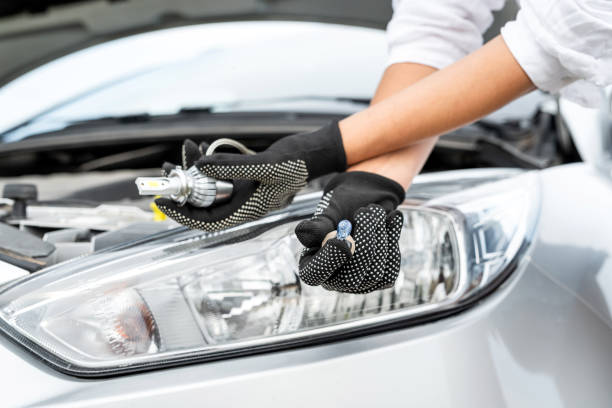 istock hand hold bulb for replacement in car. Auro repair concept 2204937101