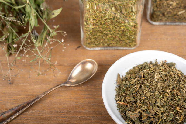 istock Herbal tea or dried herbs or medicine in jars with spoon 2204942061