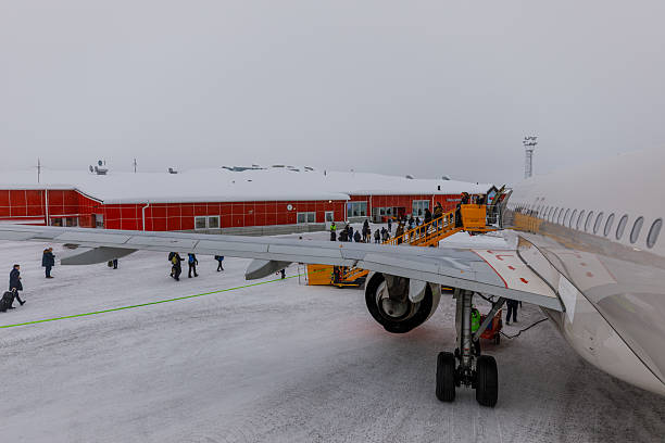 Kiruna, Sweden - 30 January 2020: Passengers disembarking from a SAS airline. Winter season. Snow on the airport runway.