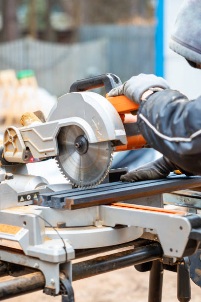 istock Worker Operating Miter Saw on Outdoor Construction Site in Cool Weather 2204945144
