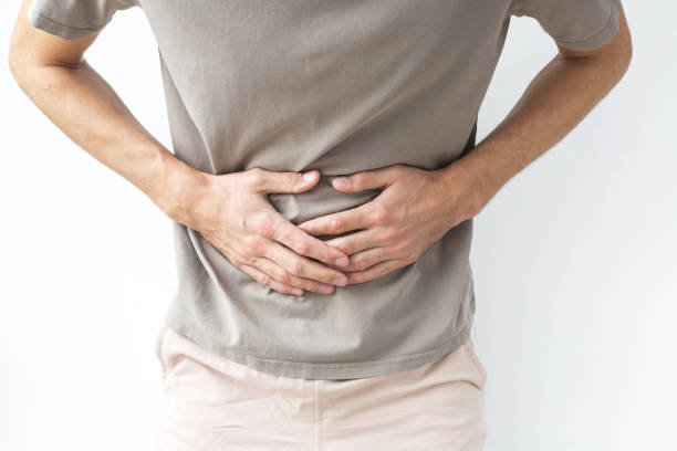 istock A man clutching his stomach in pain, possibly experiencing digestive issues, cramps, or discomfort related to health problems, Faceless 2204958026