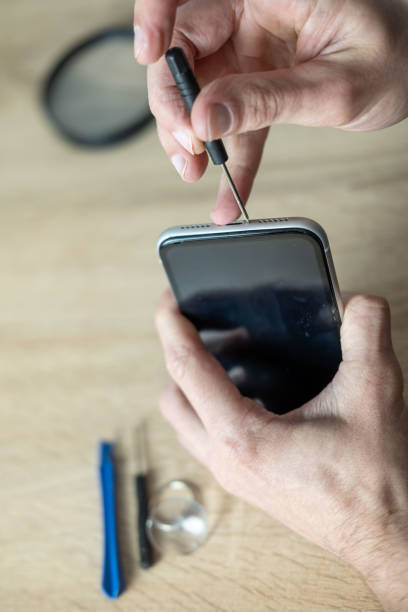 istock Hands repairing smartphone hardware with small tools. Mobile phone maintenance, repair service and technology concept, technical support, service center, display replacement 2204958780