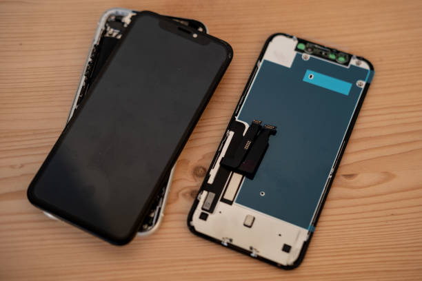 istock Damaged smartphone with cracked screen held in hands. Broken mobile device repair and maintenance concept, cracked glass screen, technical support, service center 2204960020
