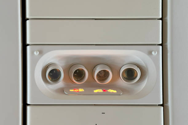 modern Airplane cabin interior, overhead panel with seatbelt and call buttons, reading light, call button, and air vent, flight experience, air journey, comfortable travel, airline industry