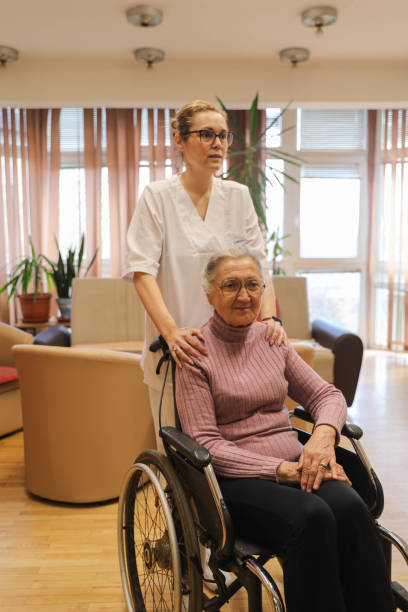 istock With Care and Respect: A Nursing Home Resident Receiving Help 2204962937