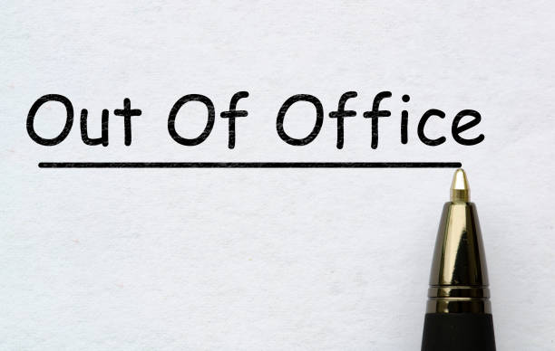 istock Out of office text on white paper. Vacation concept 2204964368