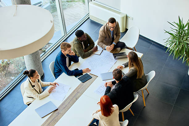 istock Team Collaboration Around a Table Discussing Business Plans in a Modern Office 2204964796
