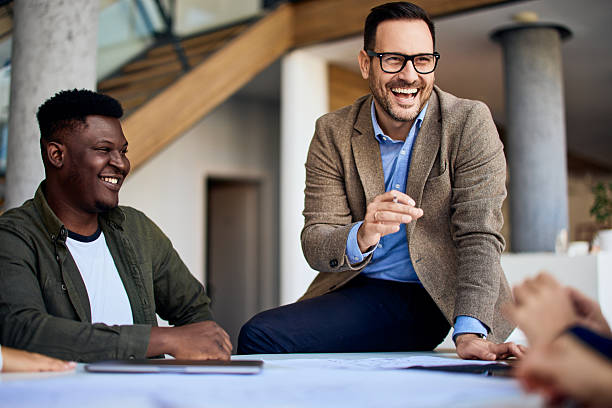istock Professional Team Laughing and Brainstorming Ideas in a Modern Office Workspace 2204964799