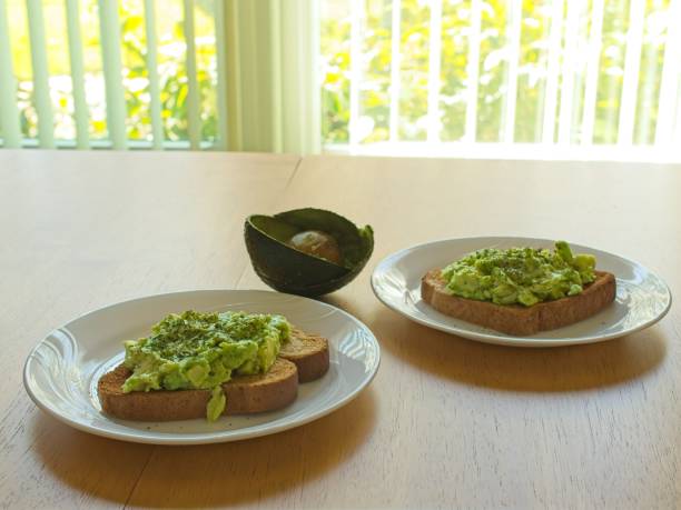 Healthy avocado toast with shell and pit in sunny window