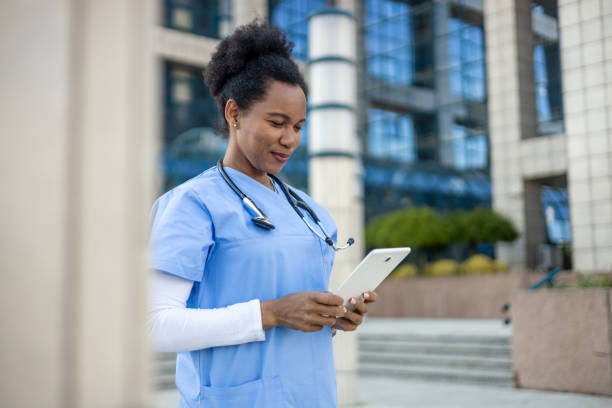 istock Confident african american doctor using digital tablet outside hospital 2204970630