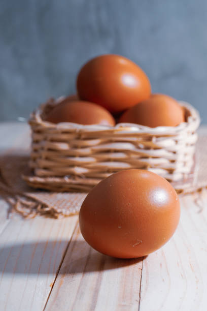 Fresh raw chicken eggs with smooth shells in shades of brown and white. Commonly used for cooking, baking, and various culinary purposes. A natural source of protein and essential nutrients.