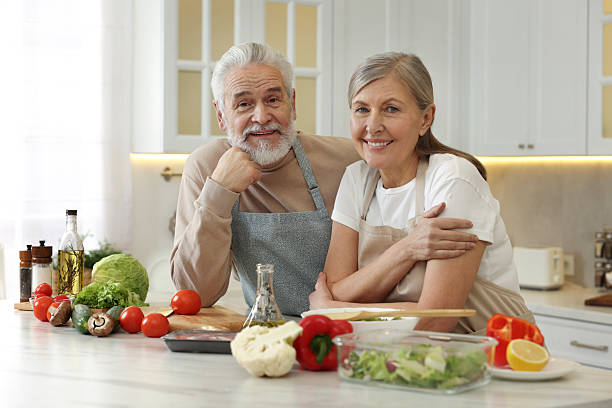 istock Happy senior couple at table in kitchen 2204972077