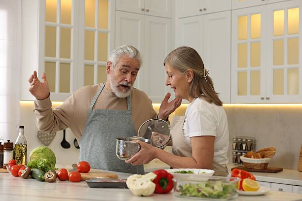 istock Lovely senior couple cooking together in kitchen 2204972083