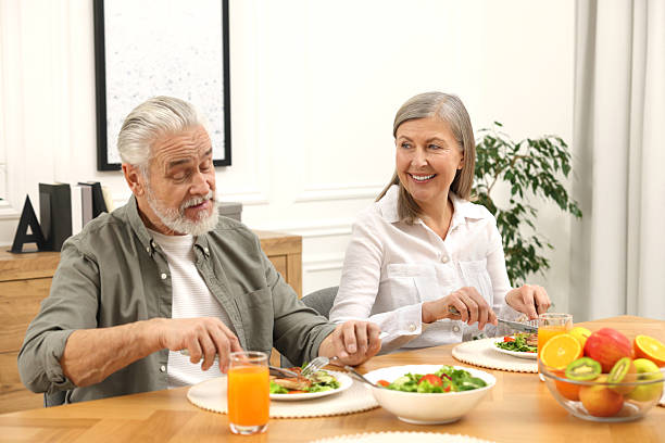 istock Happy senior couple having dinner at home 2204972173