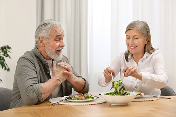 istock Happy senior couple having dinner at home 2204972202