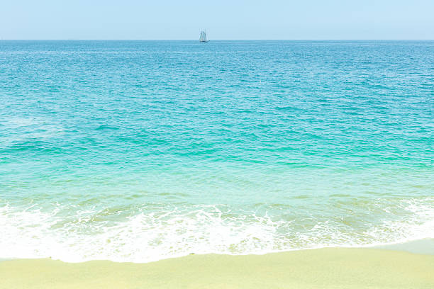 Teal Ocean Waves Sweeping Across the Juno Beach, Florida Seashore at Mid-Day in January of 2021