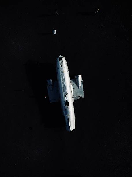 istock A plane wreck in the middle of black sand. 2204975233