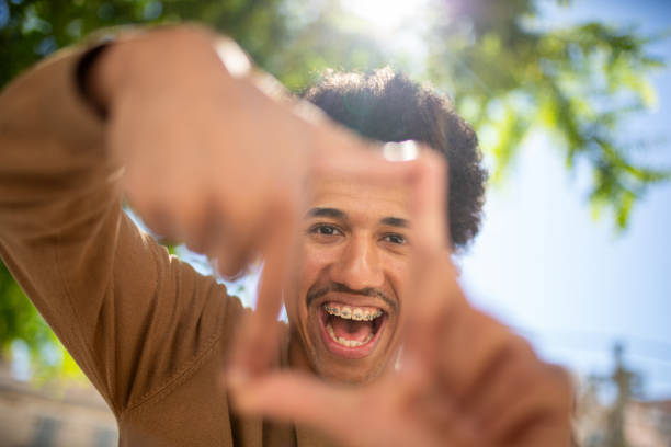 istock smiling african american man framing with hands 2204976380