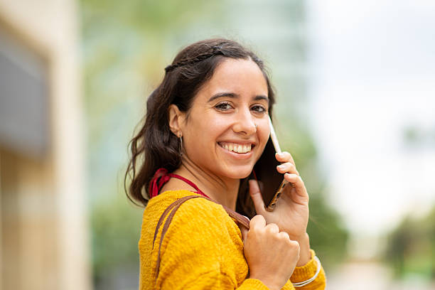 istock young woman talking with cellphone 2204984530