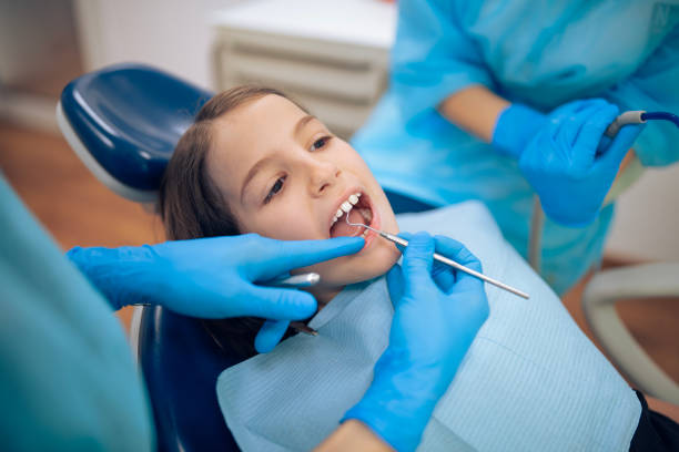 istock Dentist doing dental examination on child patient. 2204985543