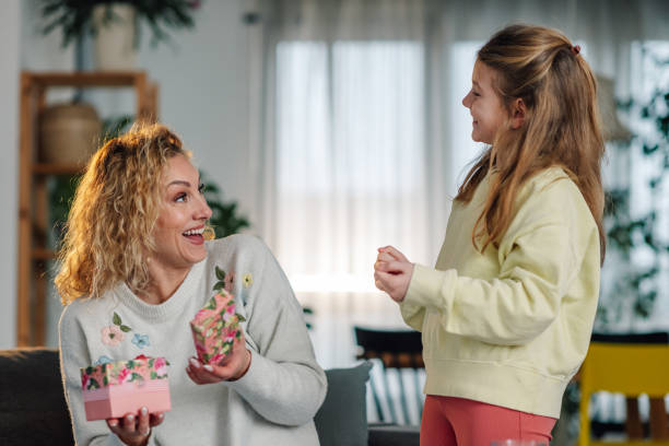 istock Daughter surprising her mother with a wonderful gift 2204986496