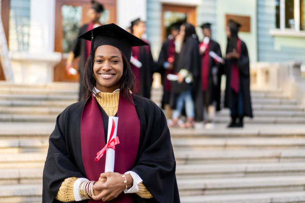 istock A girl graduate with a scroll in her hands 2204986935