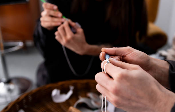 istock Young caucasian adults knitting with focused hands in a cozy setting 2204988862