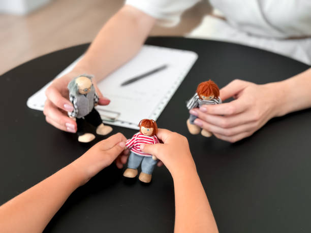 istock Child therapy session with puppet family interaction on table 2204988875