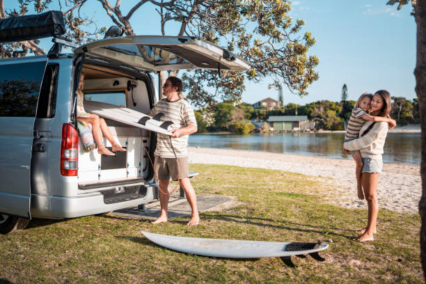 istock Caucasian Father Unloading Surfboards During Family Camping Trip 2204989262