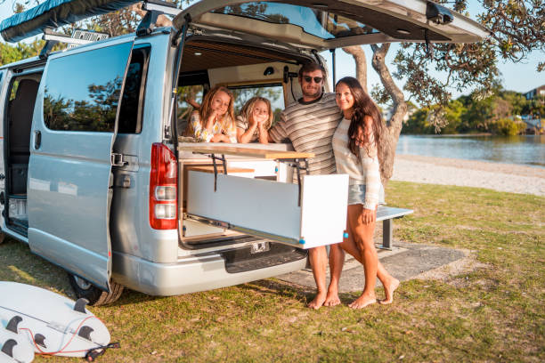 istock Joyful Caucasian Family Relaxing Outdoors by Their Camper Van 2204989298