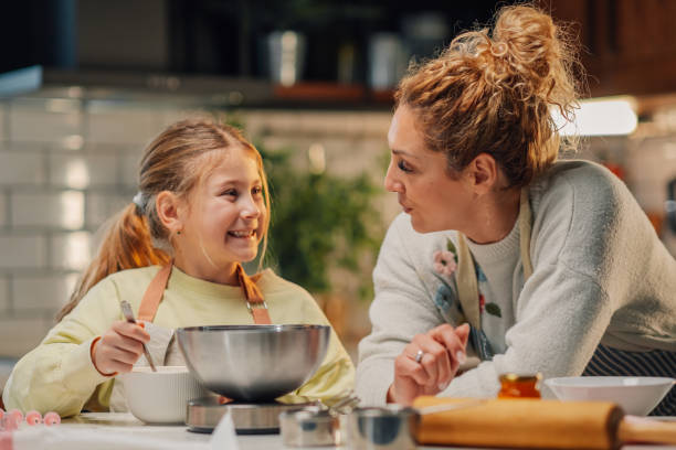 istock Mother and daughter baking together in modern kitchen, sharing a loving moment 2204991234