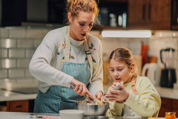 istock Mother and daughter baking together in the kitchen 2204991245