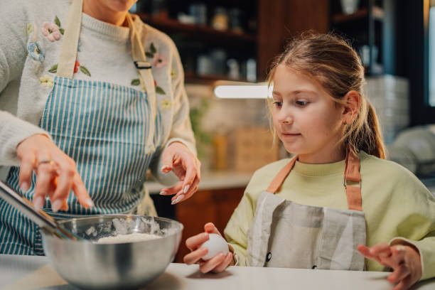istock Mother and daughter baking together in modern kitchen 2204991266