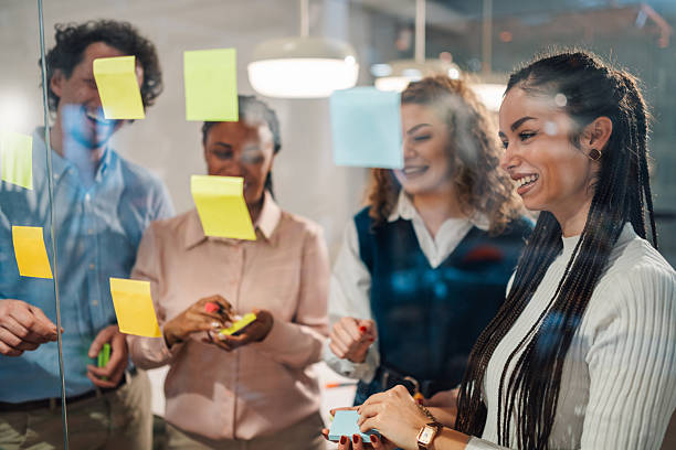 istock Business team brainstorming and planning using sticky notes on glass wall 2204991600
