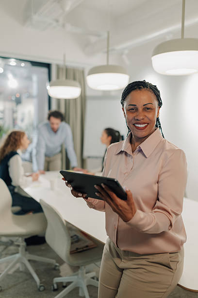 istock Smiling businesswoman using digital tablet during a meeting in the office 2204991603