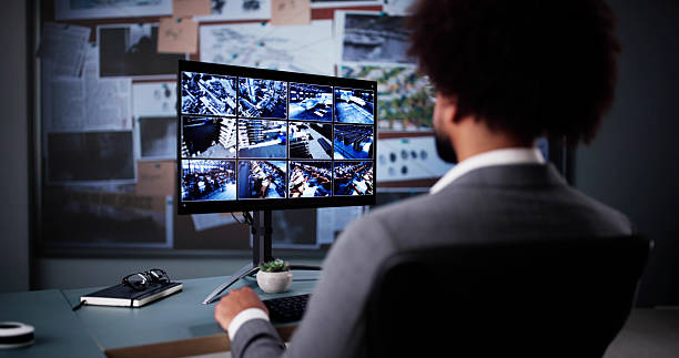 istock Intense African-American Detective Analyzing CCTV Camera Footage Online Late 2204992187