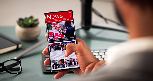 istock Man reading online news articles on mobile phone 2204992283