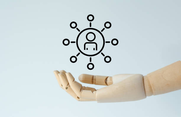 istock A hand holding a person with a circle around them 2204992953