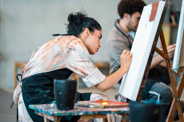 istock Young Middle Eastern Woman Creating Artwork On Canvas At Modern Art Studio Class 2204993813