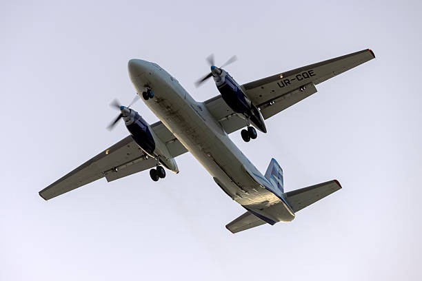 An-26 turboprop cargo plane Luqa, Malta - March 11, 2025: Vulkan Air Antonov An-26B (REG: UR-CQE) on long finals runway 31 in the sun rise. antonov an 26 stock pictures, royalty-free photos & images