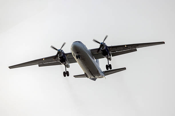 An-26 turboprop cargo plane Luqa, Malta - March 11, 2025: Vulkan Air Antonov An-26B (REG: UR-CQE) on long finals runway 31 in the sun rise. antonov an 26 stock pictures, royalty-free photos & images