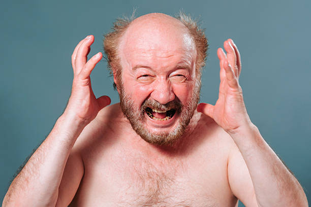 istock Man with beard expresses intense emotion while showing frustration indoors 2204995070