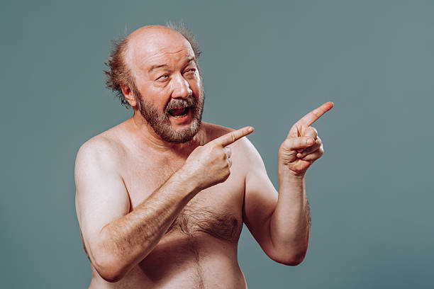 Cheerful man pointing and expressing excitement in a studio setting