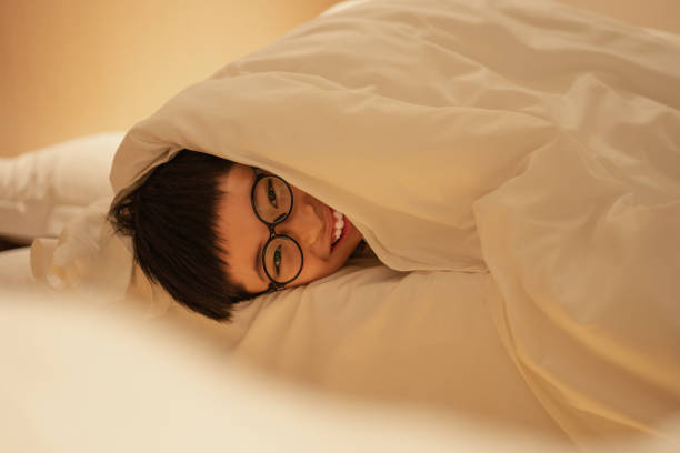 istock Asian boy playing in bed,Happy Asian boy in bed 2204999570
