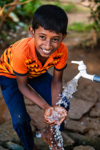 istock Sri Lankan young boy drinking a water, Ceylon 2205002339